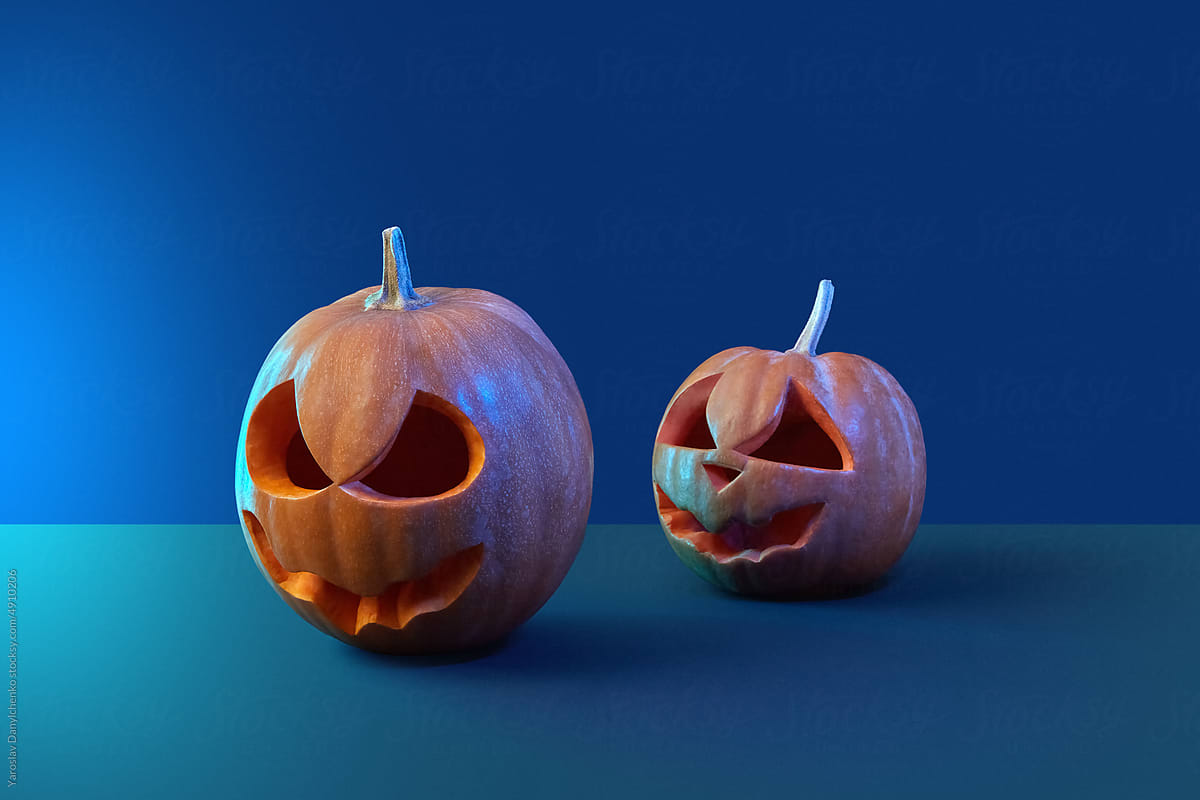 Carved pumpkins for Halloween on blue background.