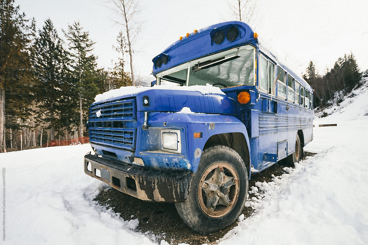 Blue school bus on snow