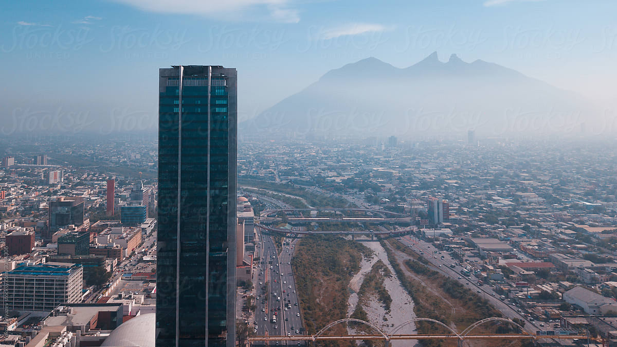 drone shot of a skyscraper against the Monterrey cityscape