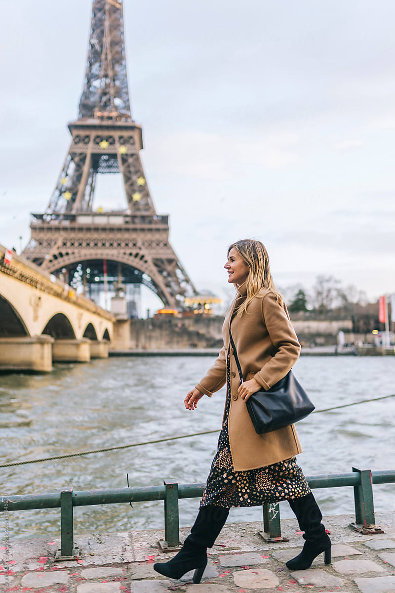 Woman near river against Eiffel Tower