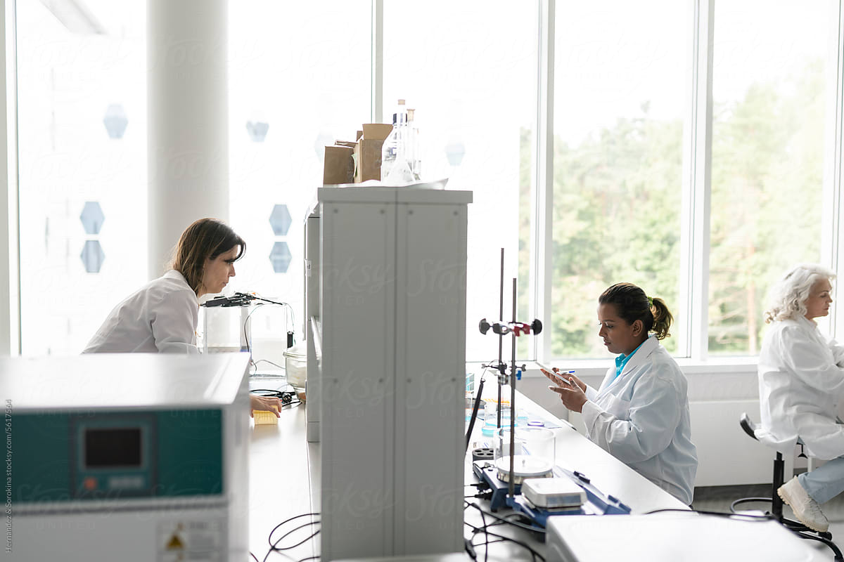 Three Female Scientists Working In Modern Laboratory