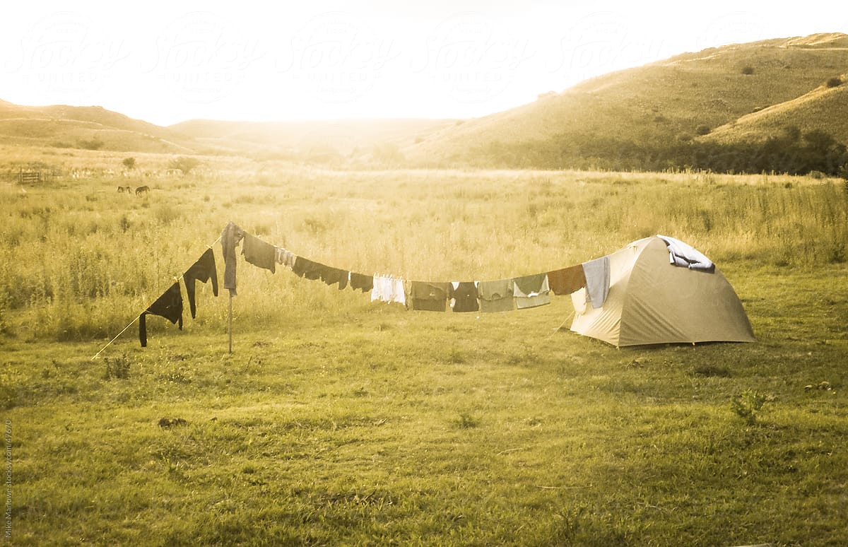 A backlit shot of a tent with washing hanging on a line
