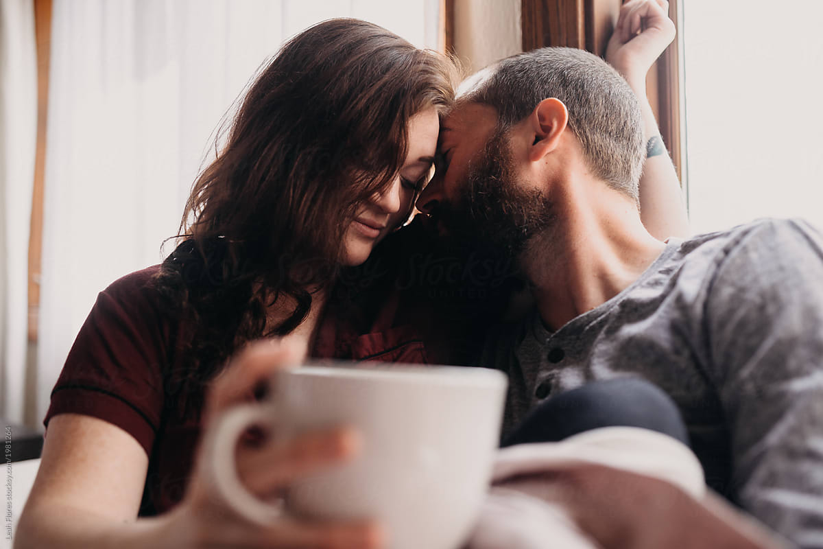 Couple Sharing Coffee In Bed