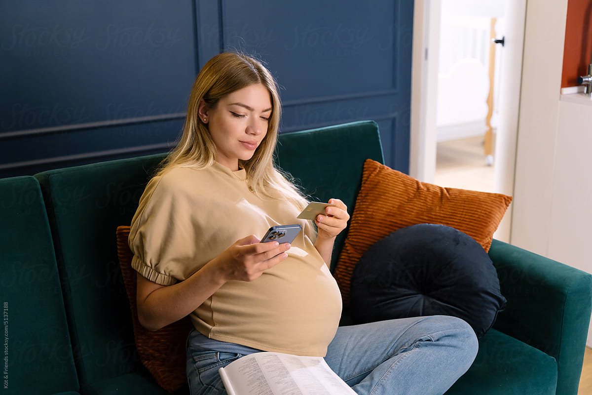 Pregnant Woman Doing Online Shopping On Cell Phone