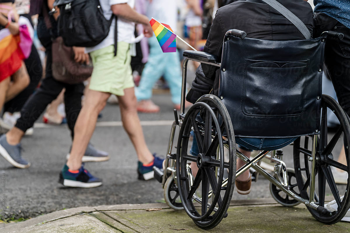 person in a wheelchair at a lgbt march
