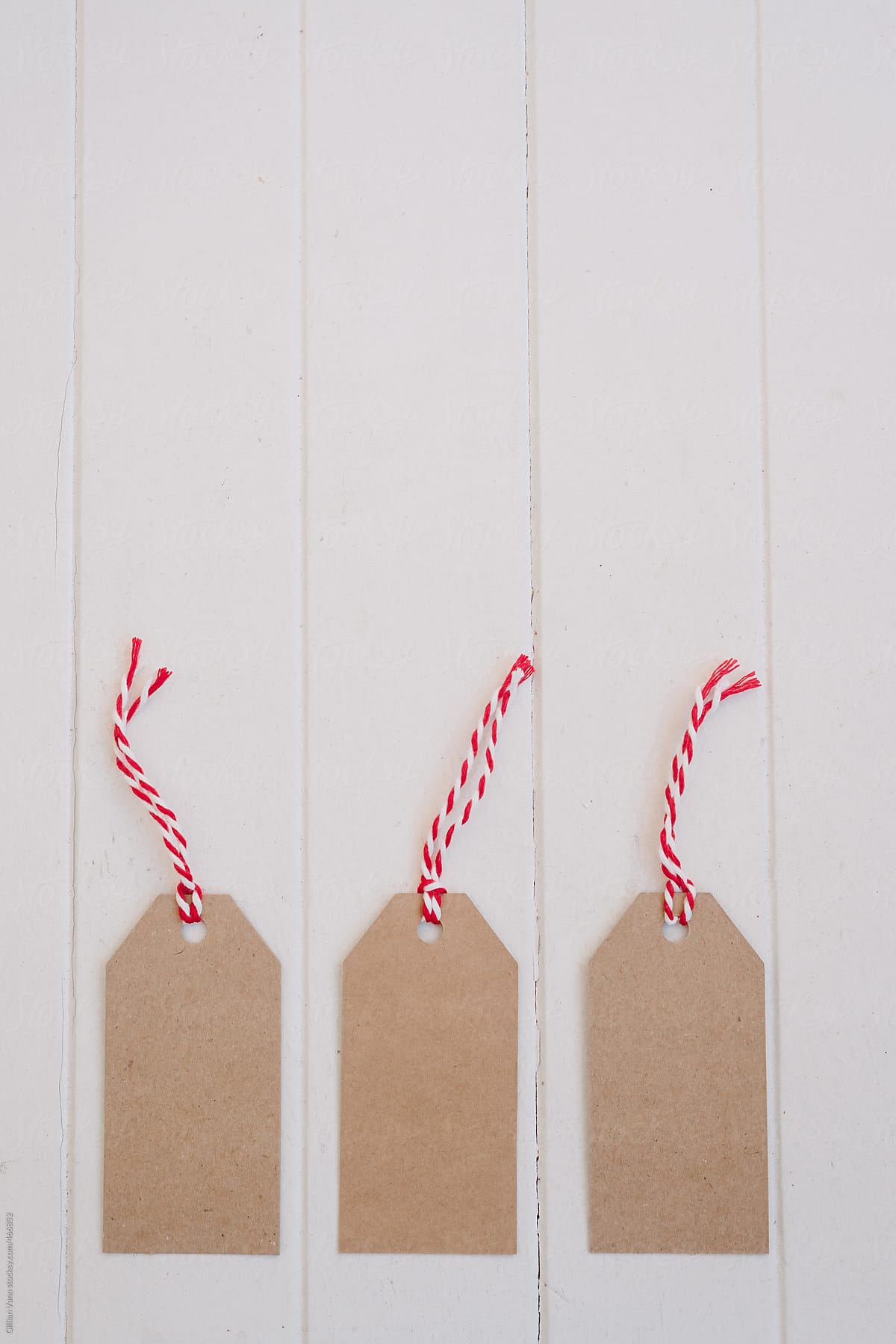 christmas tags in plain cardboard with red string