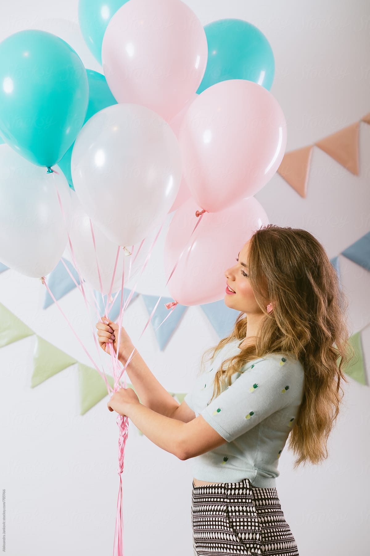 Fashionable Caucasian Woman Holding Pastel Balloons At The Party