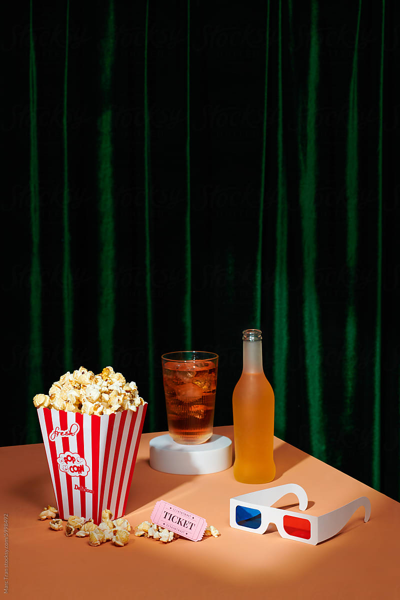 Cinema snacks. Popcorn in paper bag and soft drink near 3D glasses