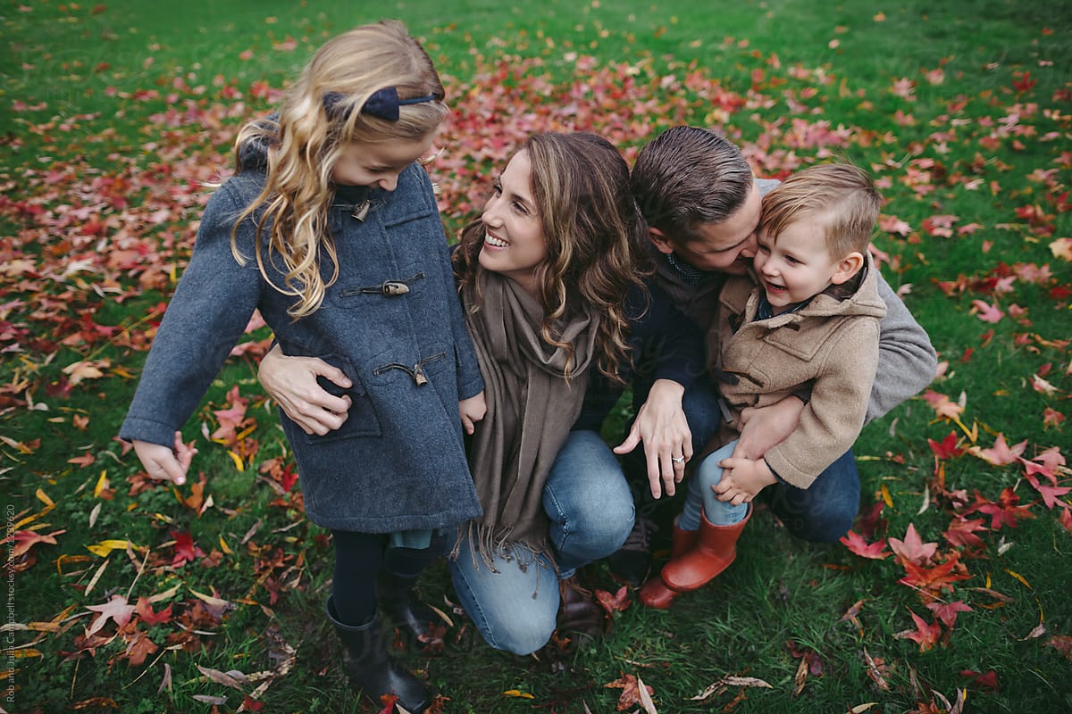 Happy family outside in colorful fall backyard