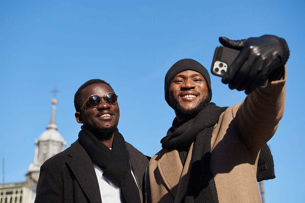 Two Happy Men friends taking a selfie the city