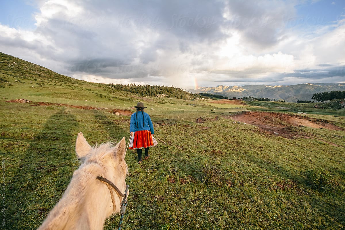 Riding a horse first person pov and a peruvian cholita guiding in Cuzco, Peru, on adventure travel