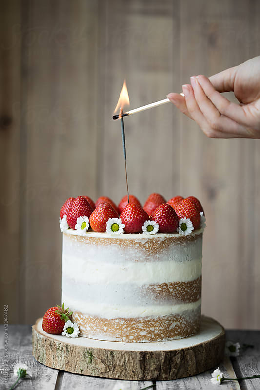 Lighting sparkler on celebration cake