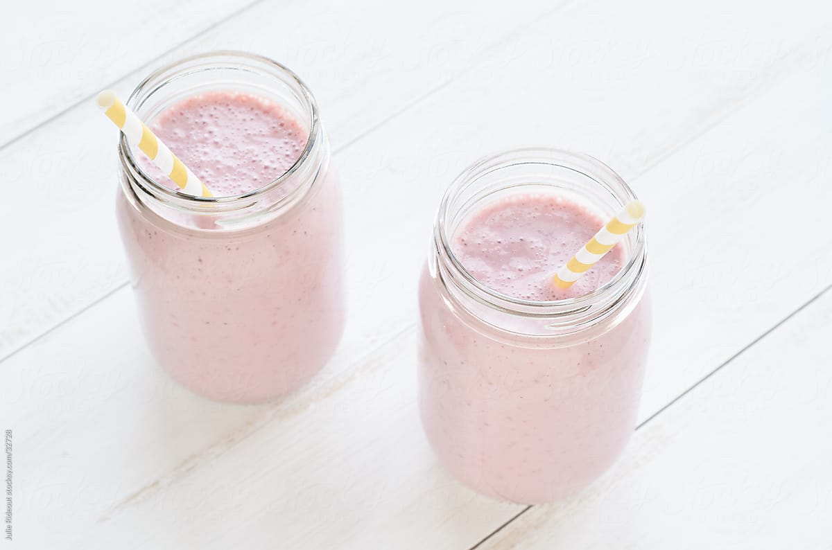 Strawberry smoothies in old-fashioned glass jars