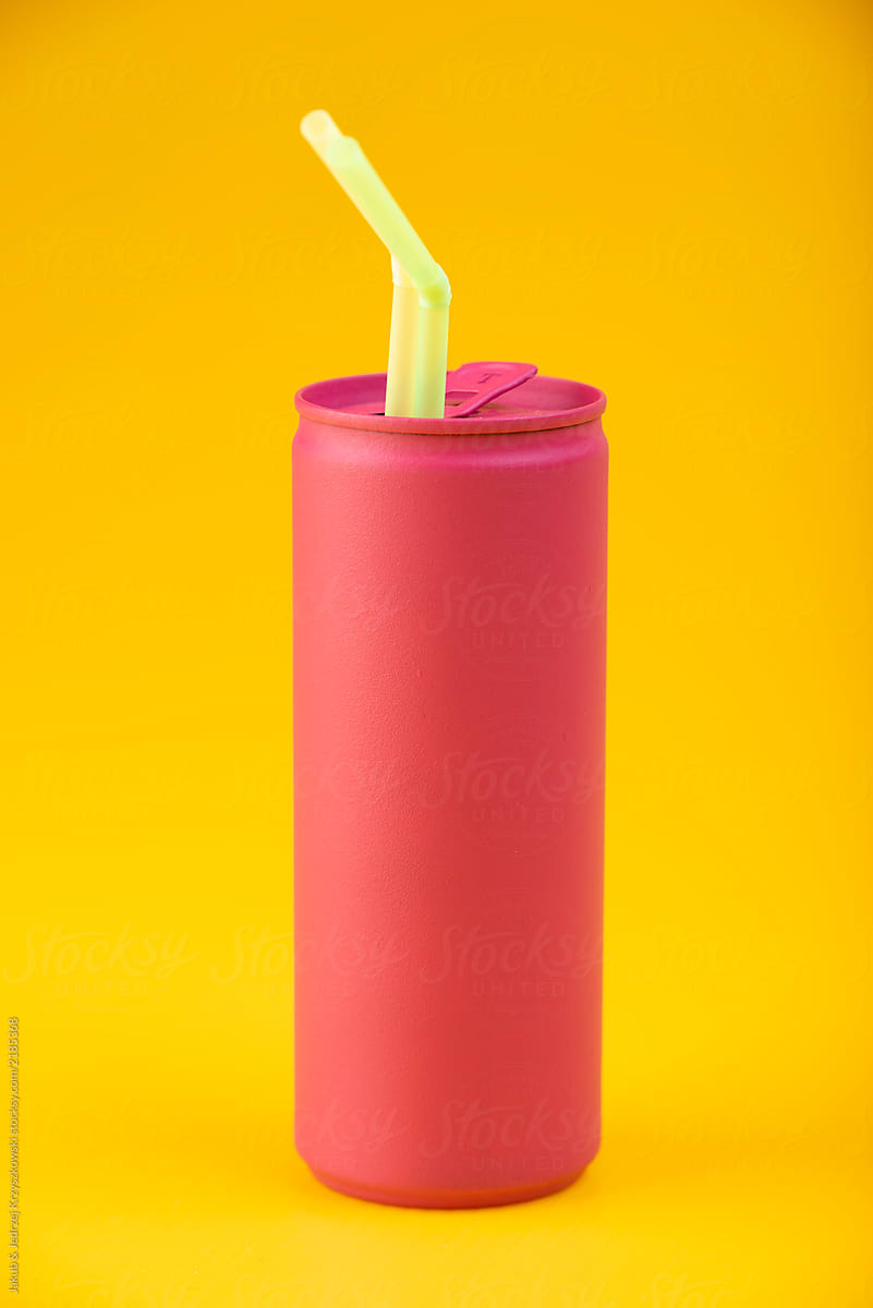 Pink can with a straws on yellow background