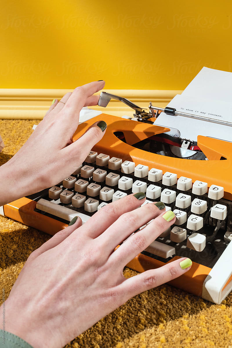 Stylish Yellow hands typing on Typewriter