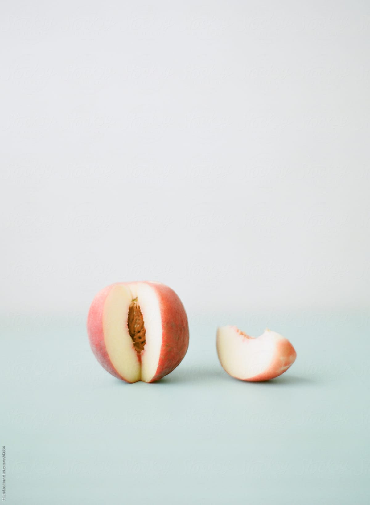 Organic white peach with a single slice taken out