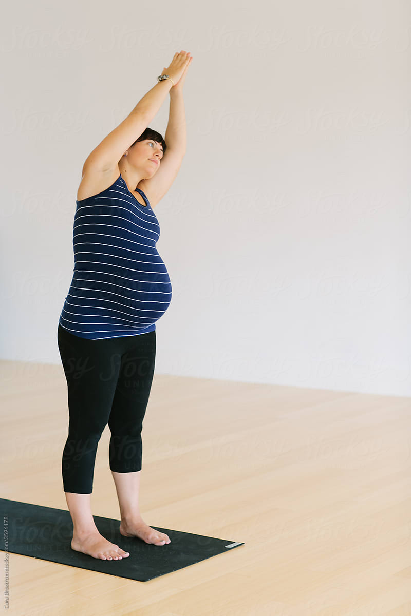 Pregnant Woman Practices Yoga - MInimalist