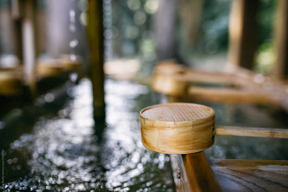 Bamboo dipper near clean fountain