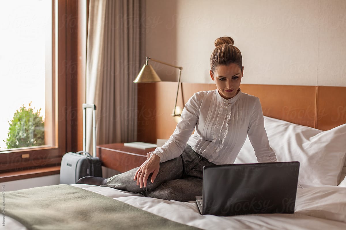Businesswoman Using Laptop in a Hotel Room