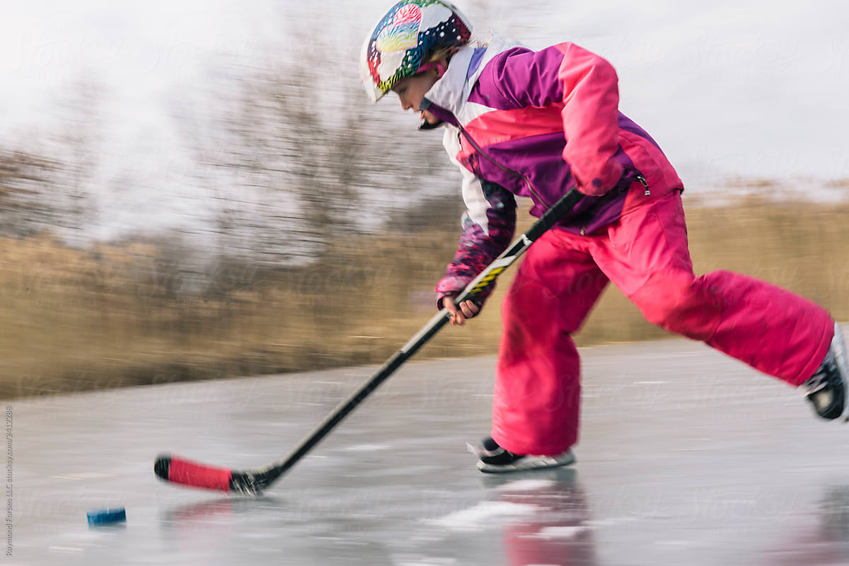 Winter lifestyle speedy  Girl Playing Pond hockey