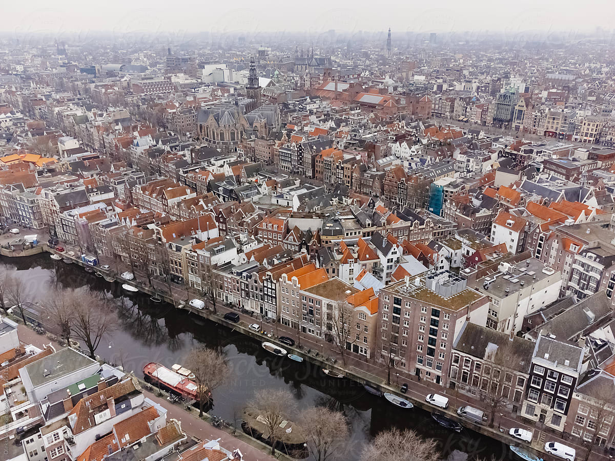Aerial view of city filled with buildings with colored roofs