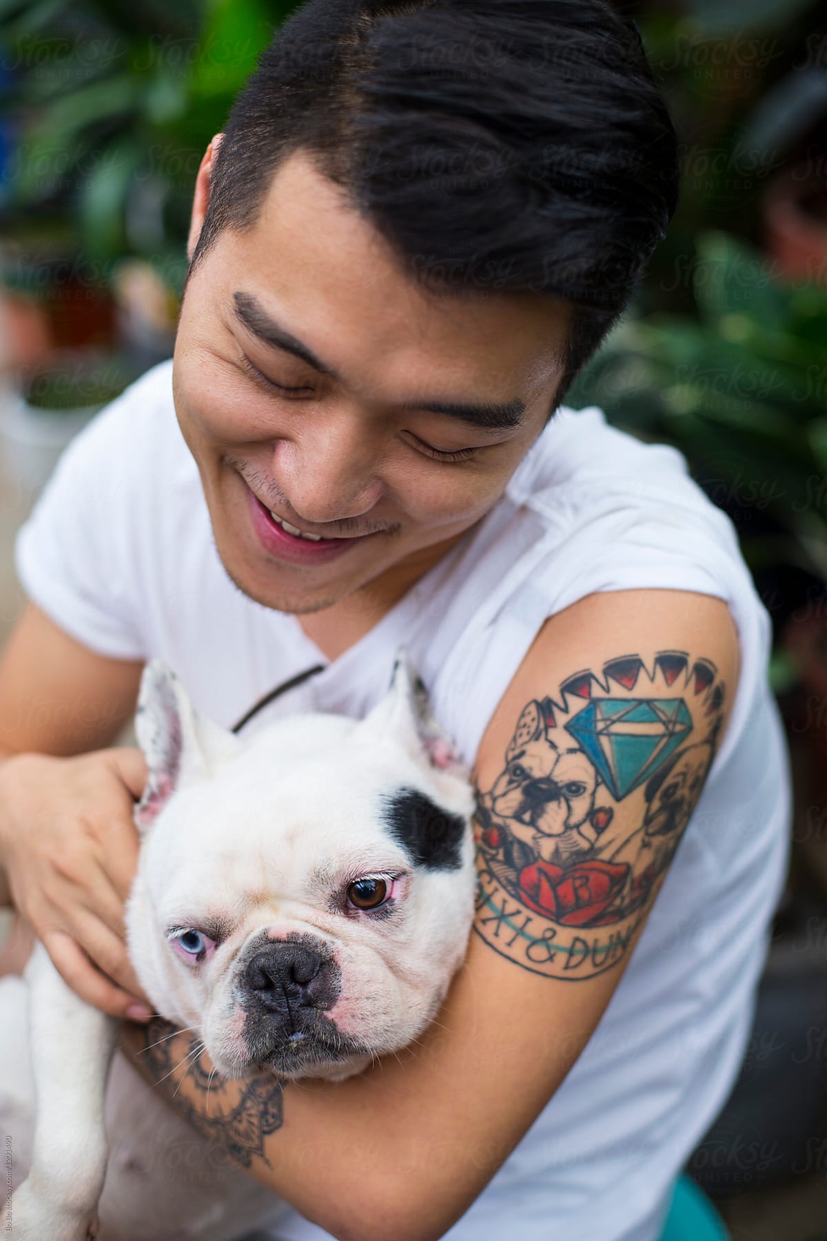 One Young Asian Man Holding his Dog