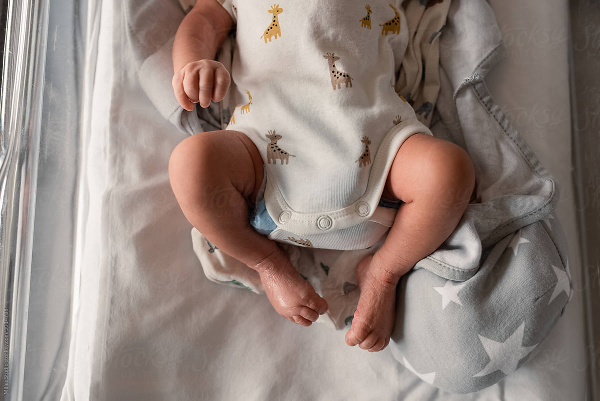 Crop infant with wrinkled feet