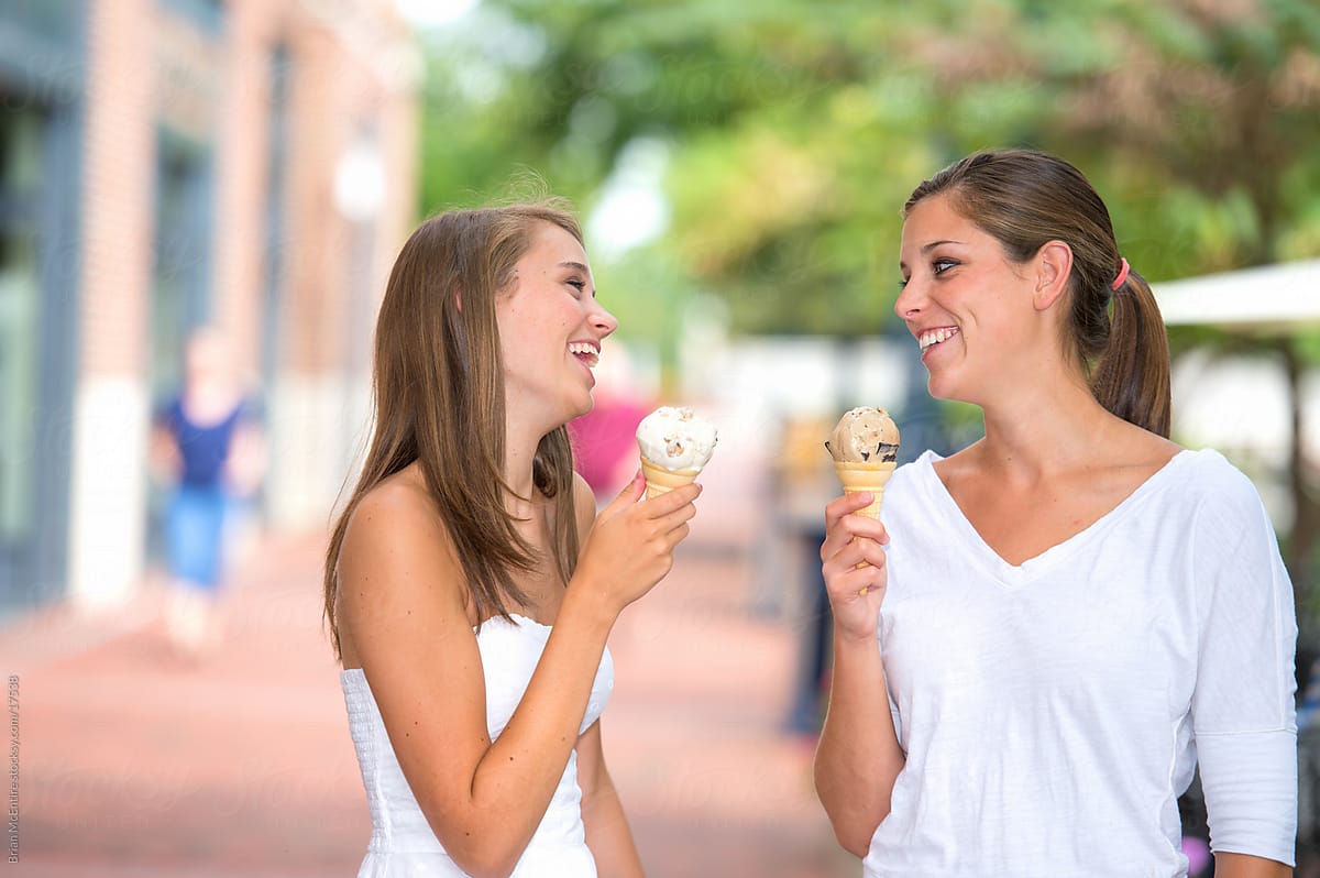 Sisters Having Ice Cream Together in Urban Setting