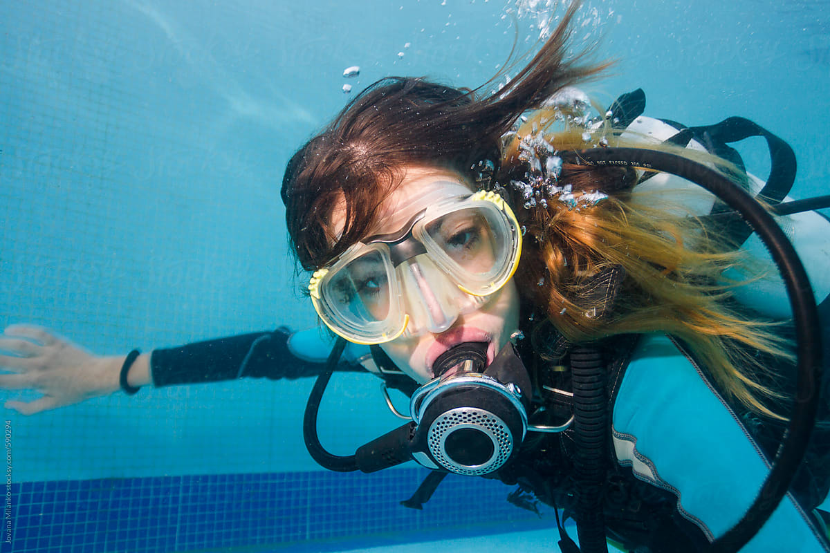 Selfie of a beautiful woman scuba diving in the swimming pool underwater. 