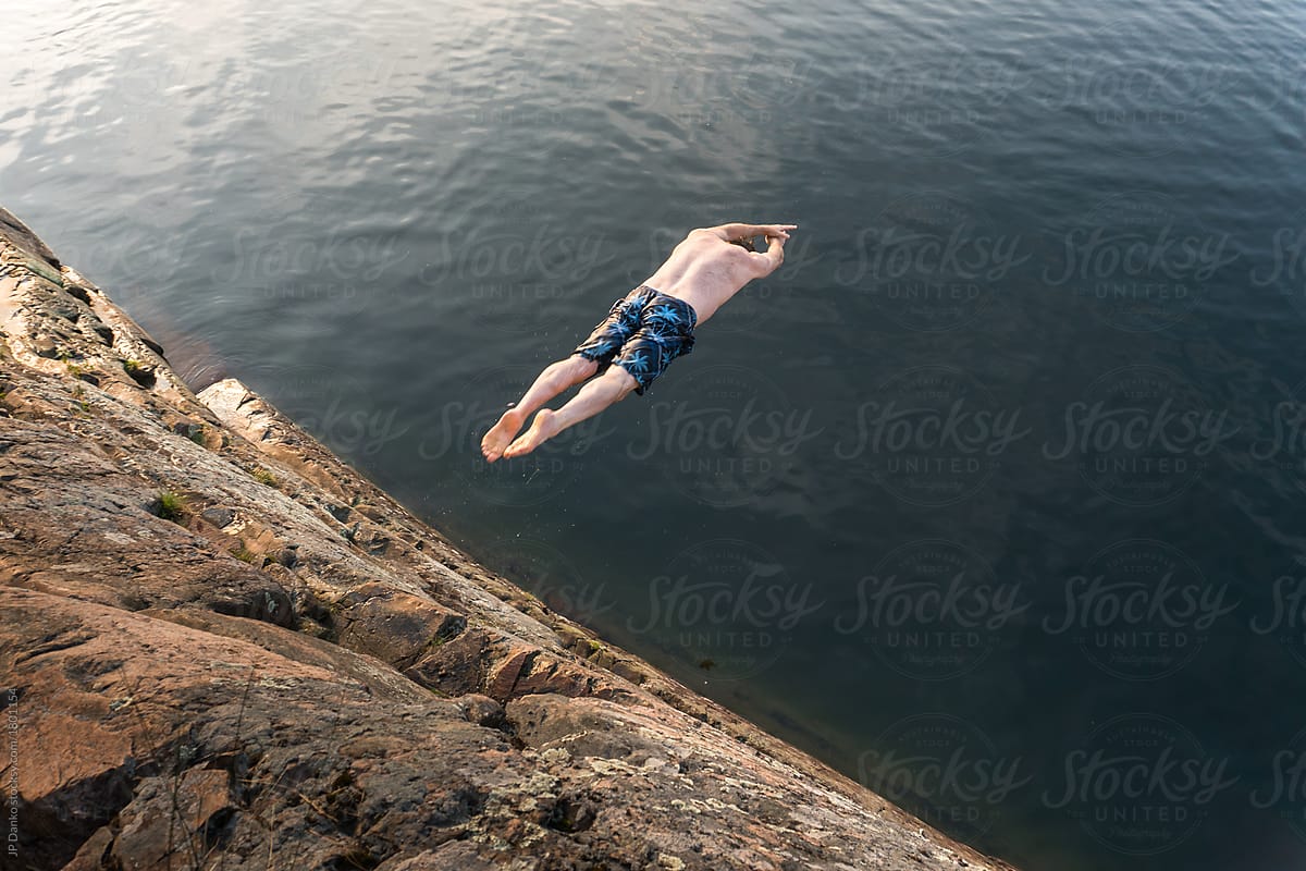 Summer Cottage Lake Man Diving Headfirst From Tall Cliff Near Killarney Provincial Park By