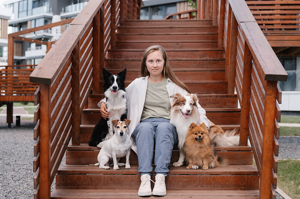 Woman with dogs sitting on steps
