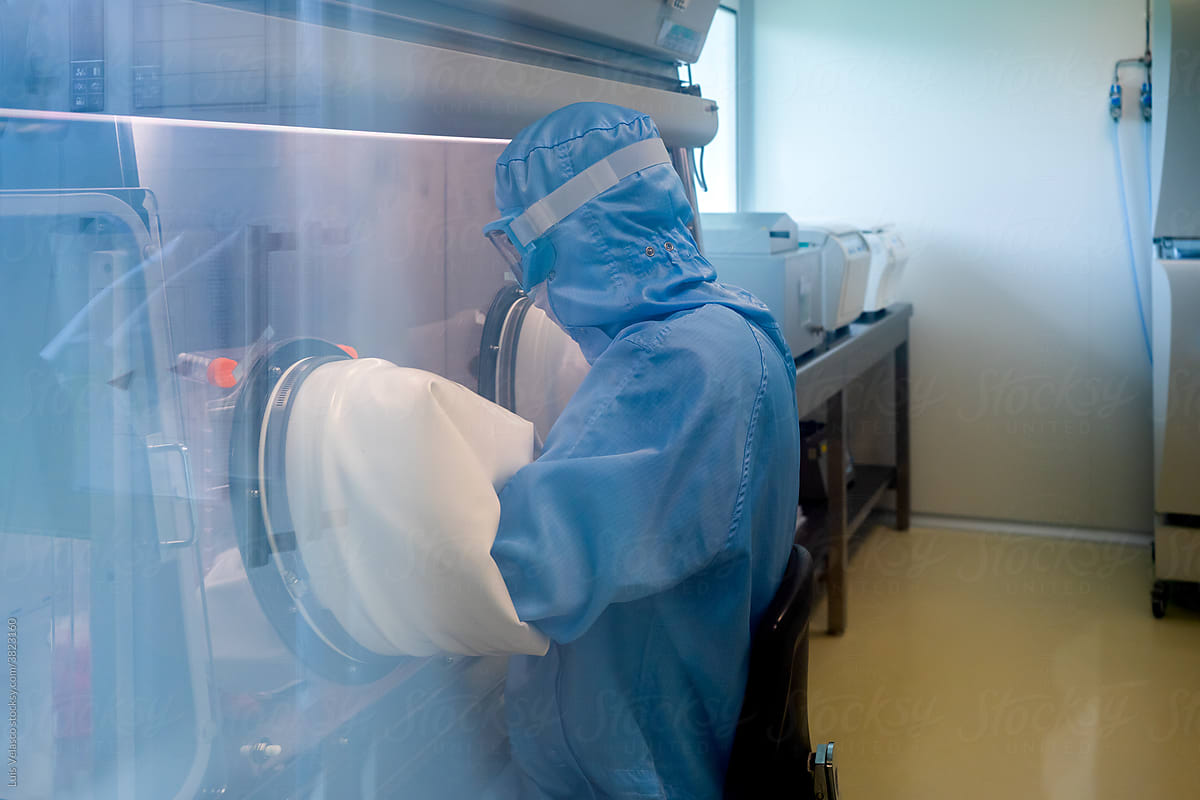 Scientist With Protective Suit Working In A Lab.