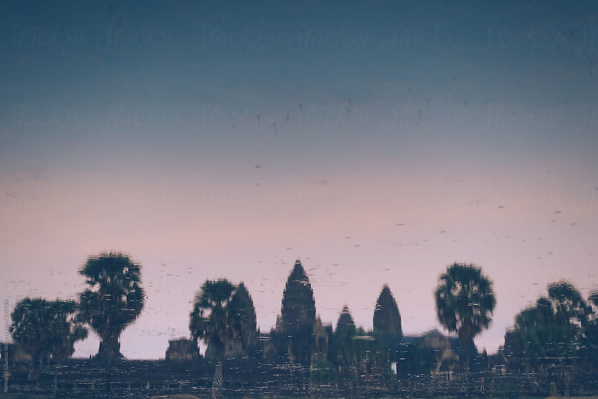 Towers of Angkor Wat Reflecting in a Pool During Sunset