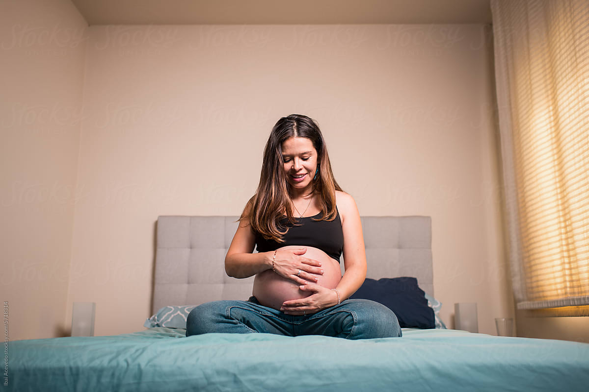 Happy pregnant woman feeling baby movement