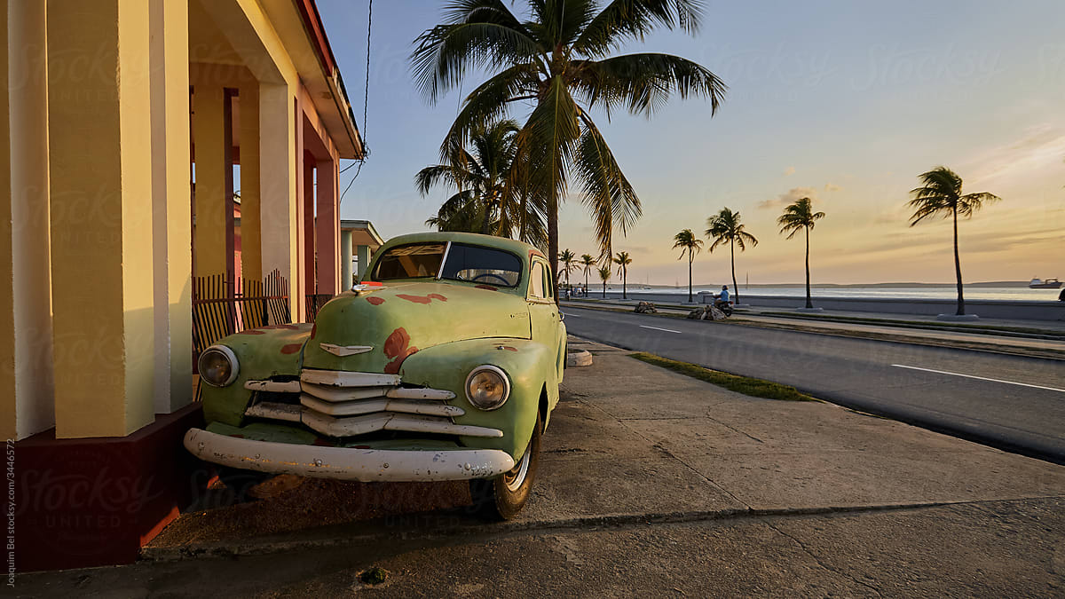 Corroded retro car at sunset