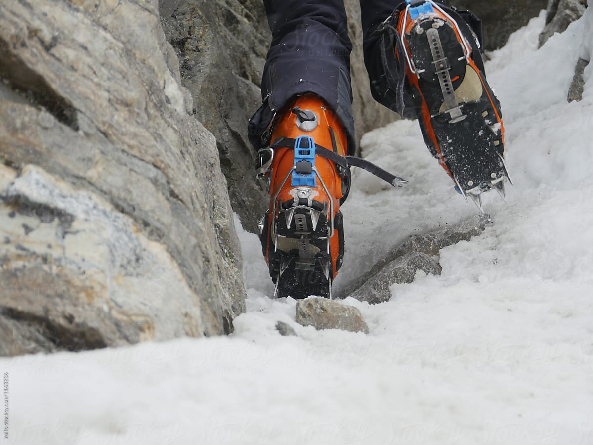 Back view of orange ski boots climbing in mountain