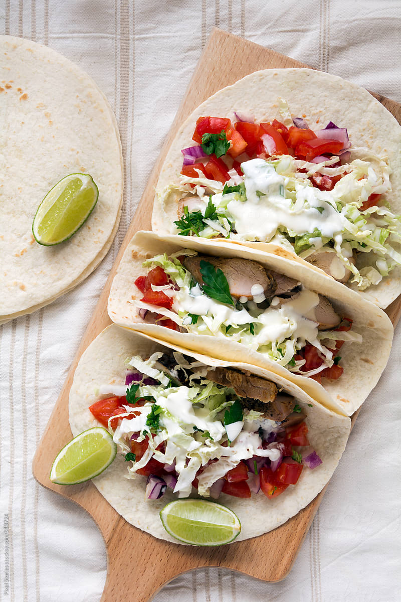 Food: Tacos with roasted chicken, sour cream and vegetables