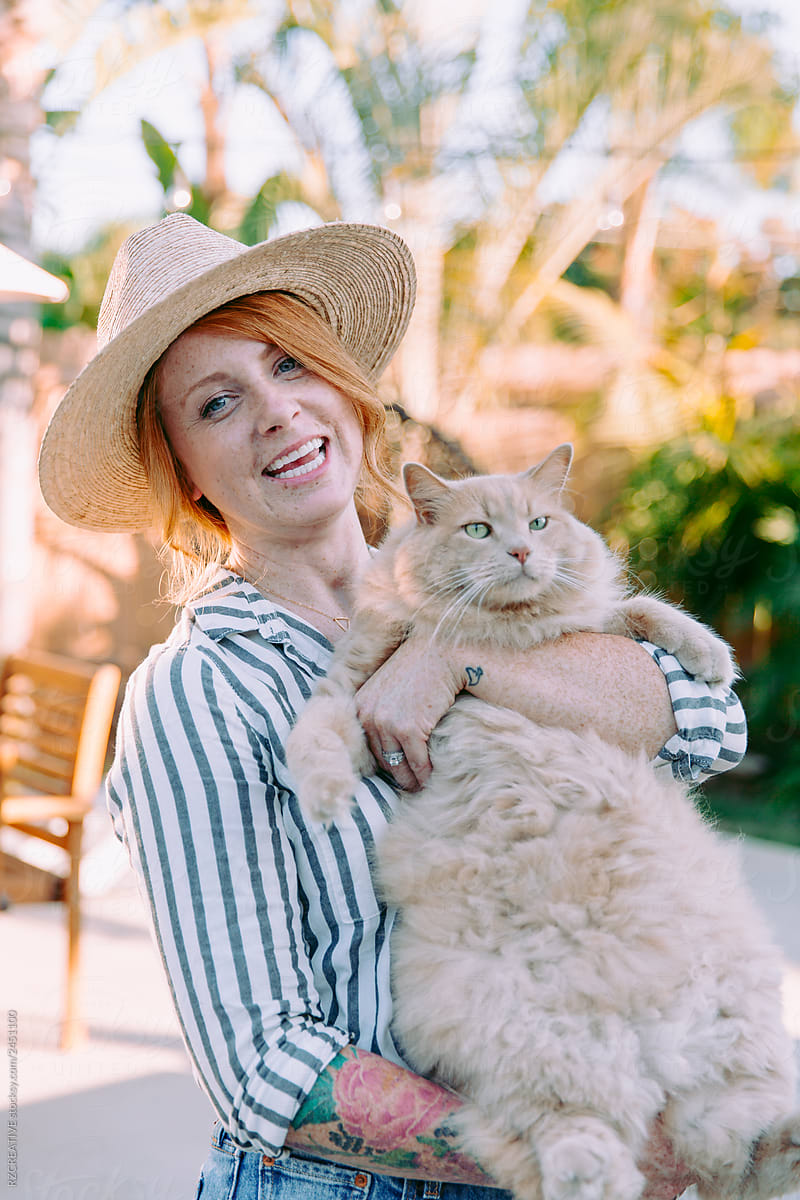 Woman holding big fluffy cat