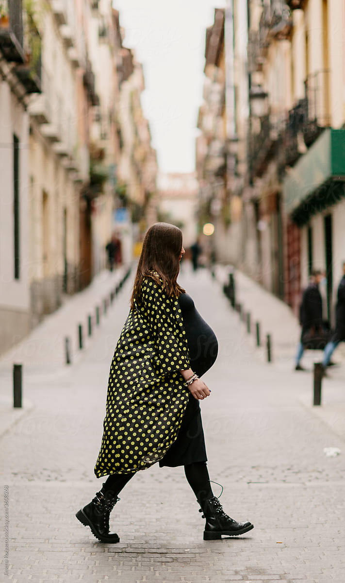 Stylish Pregnant woman walking in the street