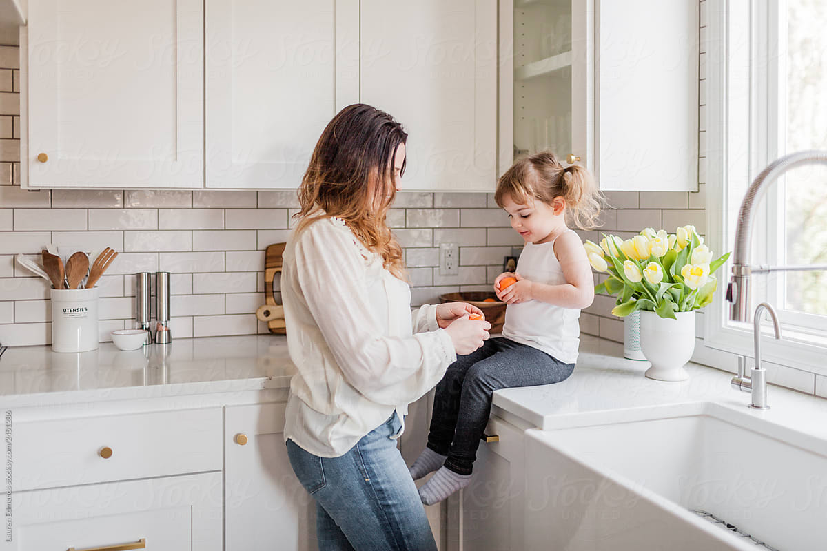 Mother and daughter eating together in kitchen