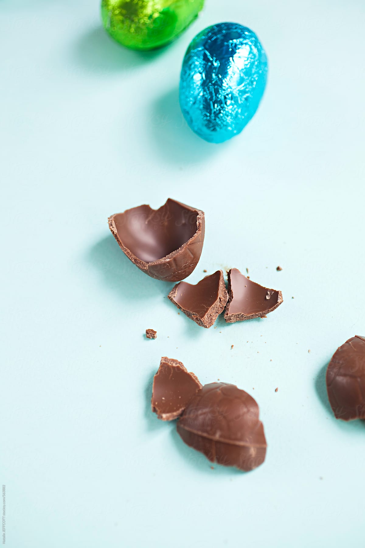 broken easter egg chocolate on a blue background