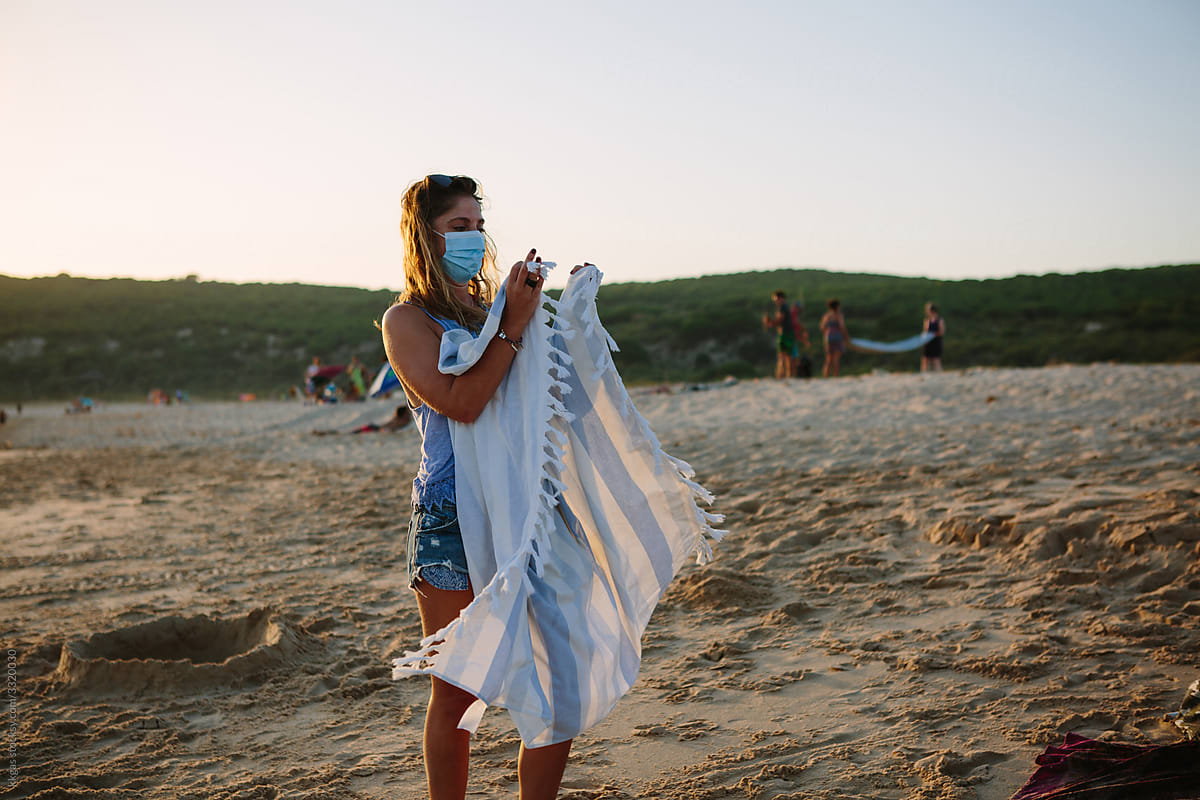 Woman folding beach towel