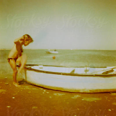 Shy Little Girl In Bathing Suit On Beach by Stocksy Contributor