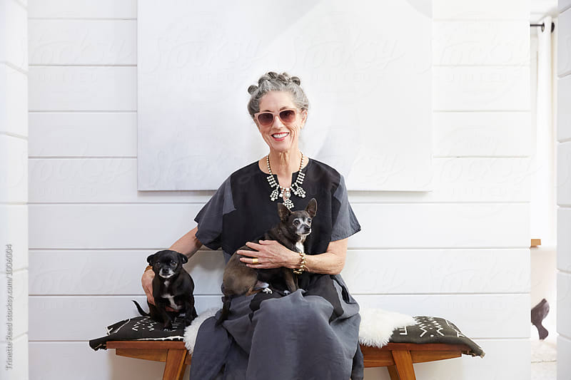 Portrait of stylish senior woman with her pet dogs