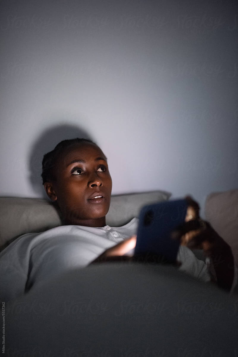Black female using cellphone at night