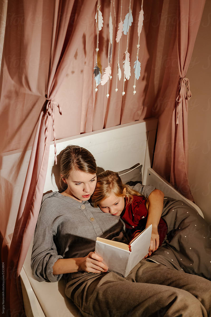 Mother reading book to child
