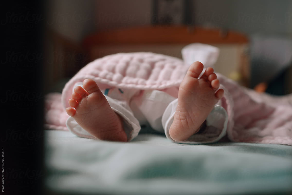 tiny feet of cute newborn baby