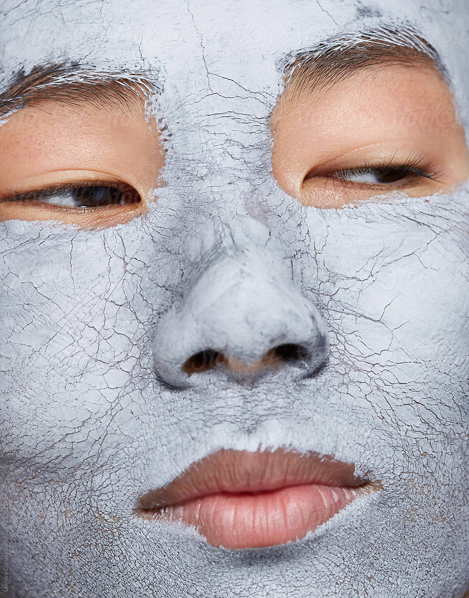 Asian Woman Closeup with Clay / Mud Face Mask Treatment