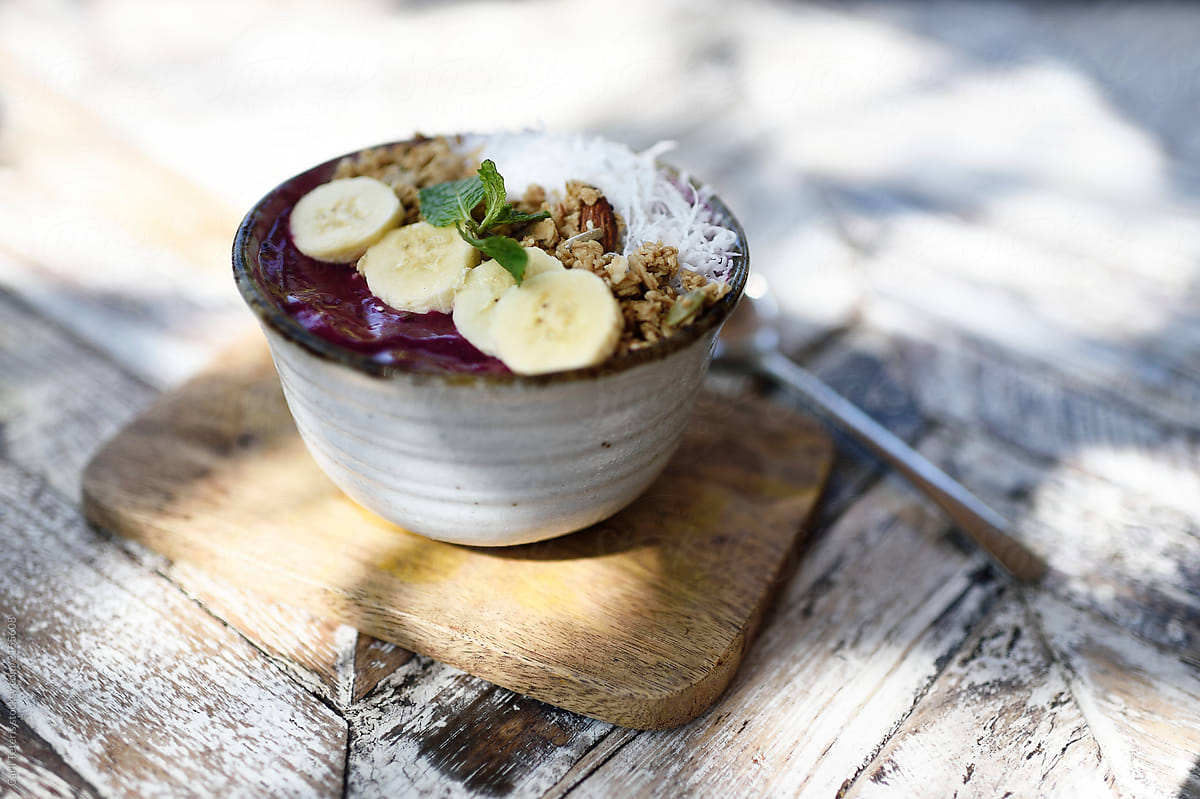 Tropical fruit smoothie bowl on a rustic outdoor table