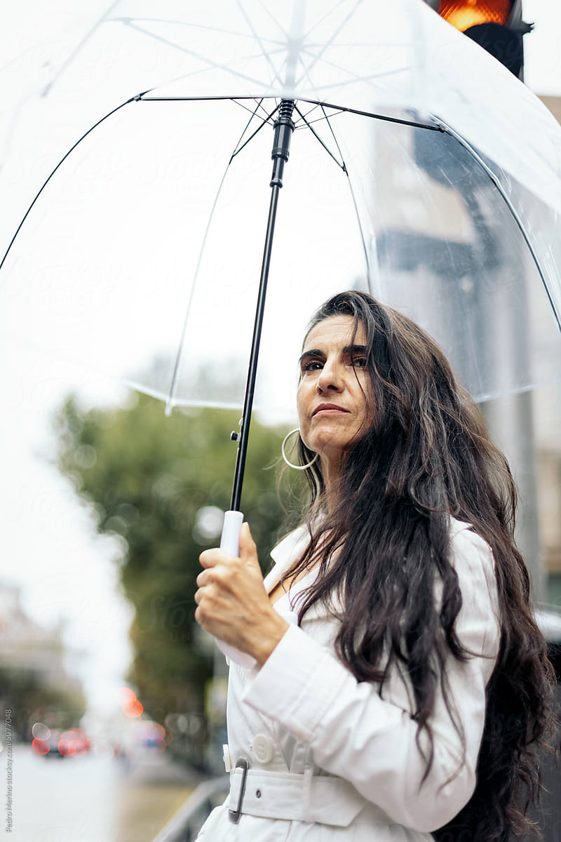 middle-aged woman with umbrella in the city